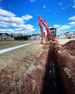 An excavator digging a deep trench