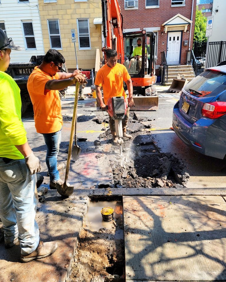 Arrow sewer & drain workers excavating a sewer line