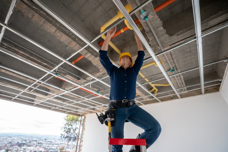 A commercial plumbing contractor works at a construction site