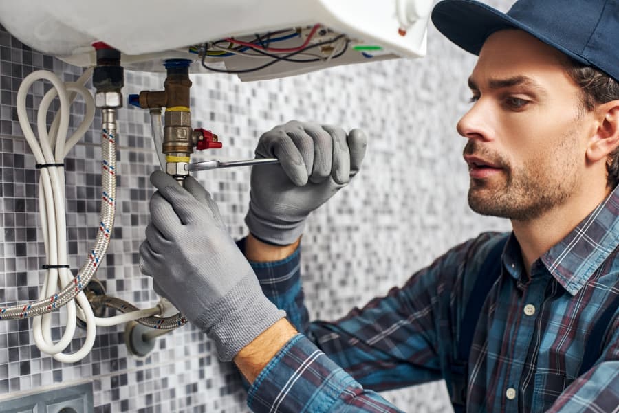 A plumber sets up an electric boiler