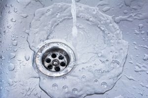 Running water draining in the kitchen sink