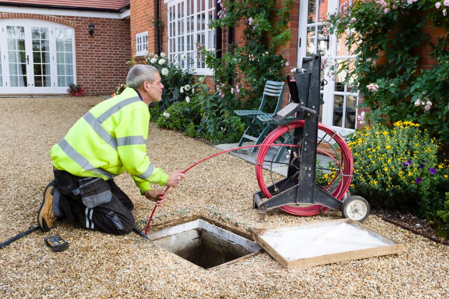 Trained technician scoping a pipe to look for problem areas