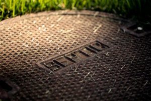 Septic tank top on a green lawn