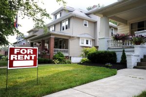 Suburban home with “For Rent” sign on lawn