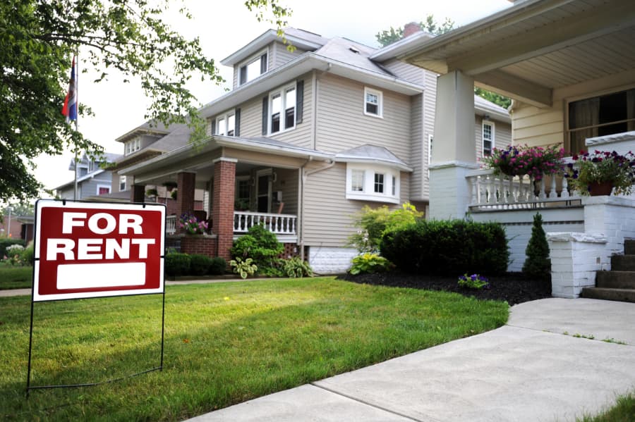 Suburban home with “For Rent” sign on lawn