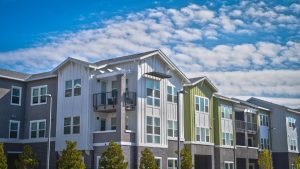 attractive-multicolor-apartment-building-with-cloudy-sky-behind-it