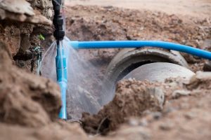 Blue water line burst spraying water